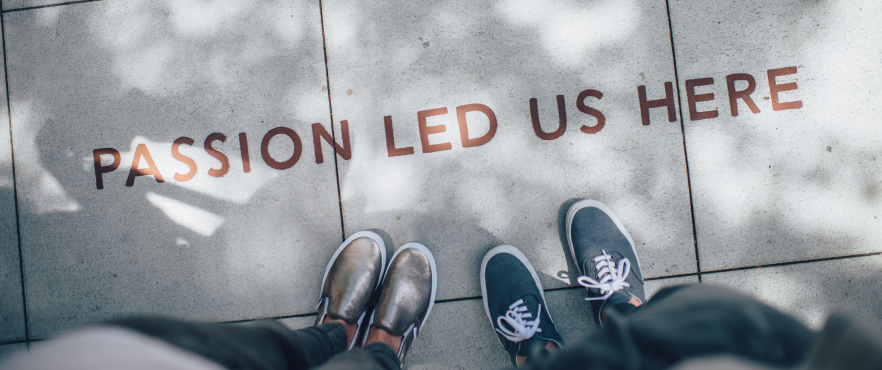 Bird's eye view of two people standing with a text overlay saying: Passion led us here.